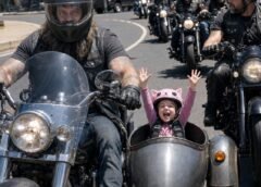 The biggest man on our street rolled out of the garage carrying a bright pink Hello Kitty helmet for our daughter